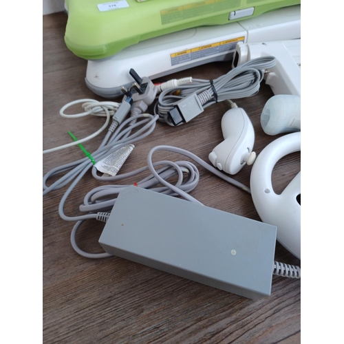 578 - A collection of Nintendo Wii items to include console, two Wii remotes with nunchucks, power adapter... 