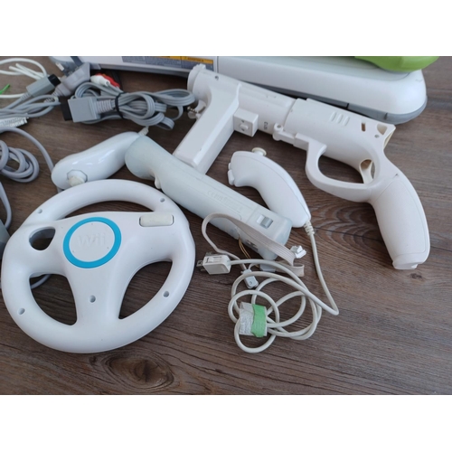 578 - A collection of Nintendo Wii items to include console, two Wii remotes with nunchucks, power adapter... 