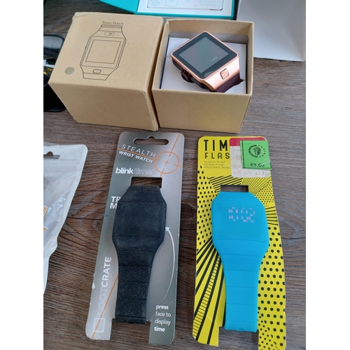 581 - A collection of fitness wristbands and smart watches to include boxed Fitbit Alta, Watchu Guardian G... 