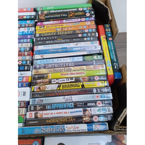 594 - A box containing a collection of DVDs and CDs - see images for titles