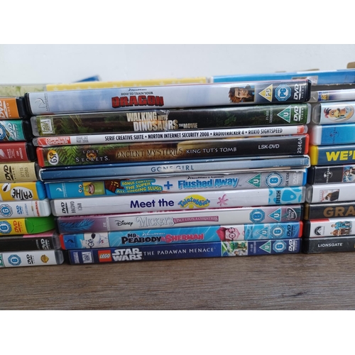 594 - A box containing a collection of DVDs and CDs - see images for titles