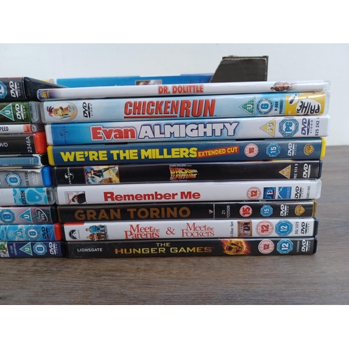 594 - A box containing a collection of DVDs and CDs - see images for titles