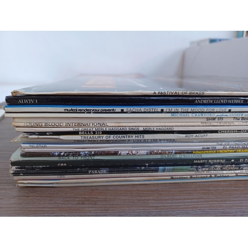 595 - A box containing a collection of DVDs and LP vinyl records - see images for titles