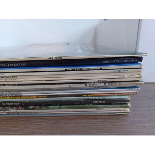 595 - A box containing a collection of DVDs and LP vinyl records - see images for titles