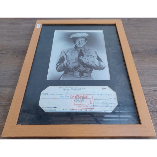 628 - A frame containing a cheque signed by Phil Silvers and a photograph of Phil Silvers as Sergeant Bilk... 