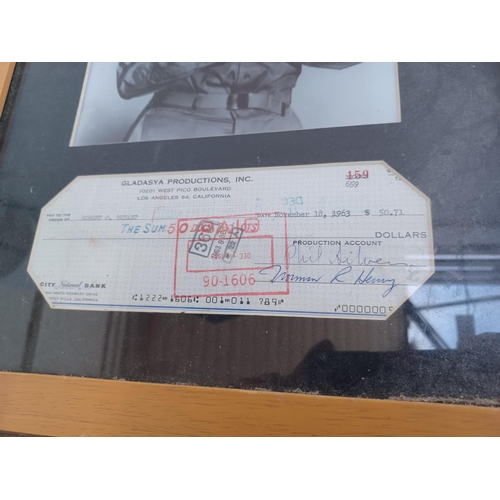 628 - A frame containing a cheque signed by Phil Silvers and a photograph of Phil Silvers as Sergeant Bilk... 