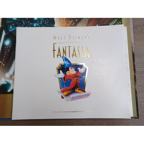 638 - A collection of film memorabilia to include Walt Disney's Fantasia commemorative book and lithograph... 