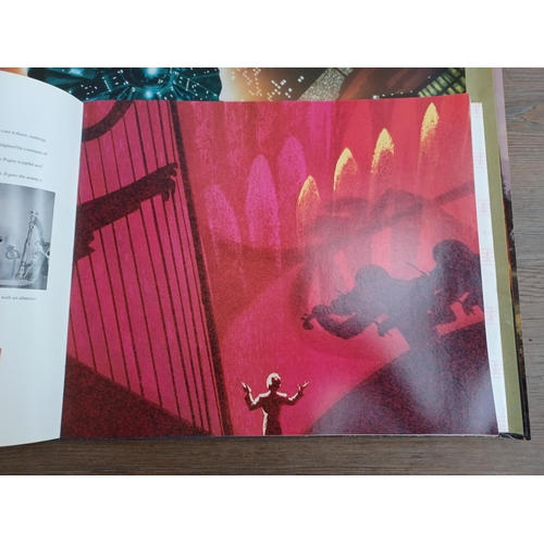 638 - A collection of film memorabilia to include Walt Disney's Fantasia commemorative book and lithograph... 