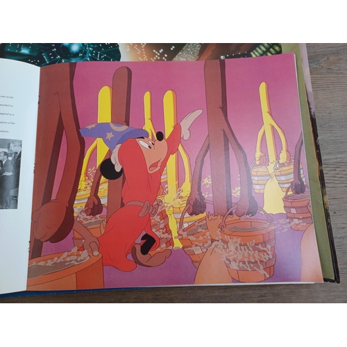 638 - A collection of film memorabilia to include Walt Disney's Fantasia commemorative book and lithograph... 