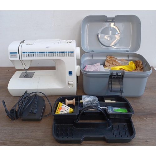 639 - Two items, one Toyota RA41 electric sewing machine with foot pedal and power cable and one sewing bo... 