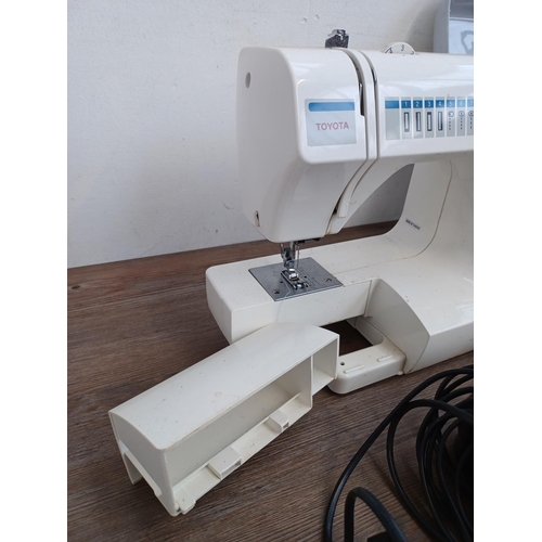 639 - Two items, one Toyota RA41 electric sewing machine with foot pedal and power cable and one sewing bo... 