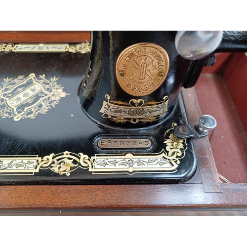 642 - A cased Singer hand crank sewing machine (serial no. EB587240)