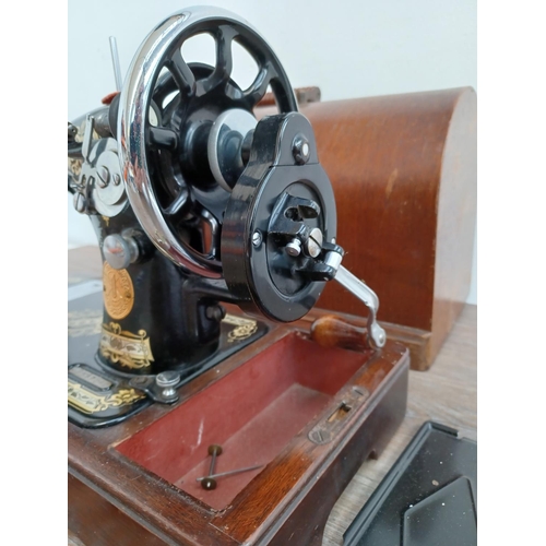 642 - A cased Singer hand crank sewing machine (serial no. EB587240)