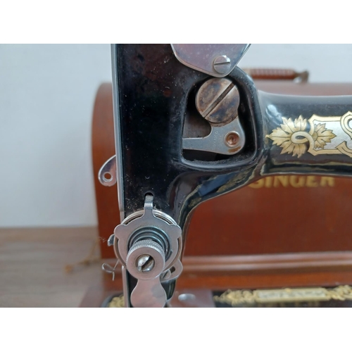 642 - A cased Singer hand crank sewing machine (serial no. EB587240)