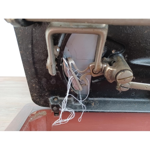 642 - A cased Singer hand crank sewing machine (serial no. EB587240)