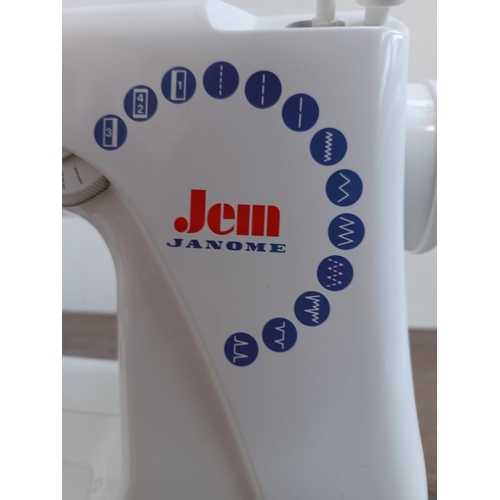 643 - A Jenome Jem electric sewing machine with foot pedal, power cable and cover