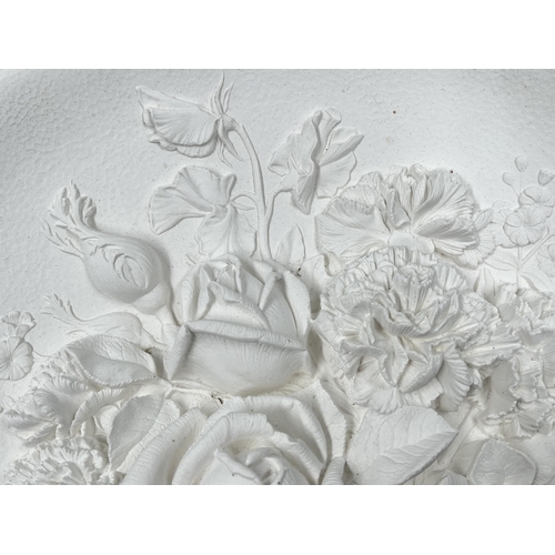 104 - A Bossons Roses and Carnations unpainted circular chalkware wall plaque - approx. 36.5cm diameter