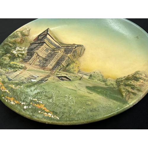 141 - A 1948 Bossons Little Moreton Hall, Cheshire chalkware wall plaque - approx. 36.5cm diameter