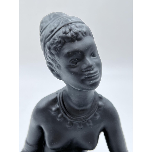 64 - A boxed Bossons African black painted pottery figurine of an African Lady - measuring approx. 19cm h... 