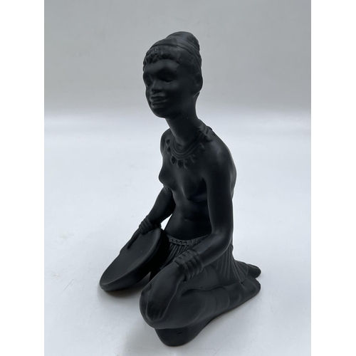 64 - A boxed Bossons African black painted pottery figurine of an African Lady - measuring approx. 19cm h... 