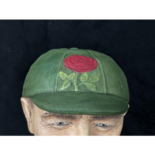 74 - A 1995 Bossons Cricketer dark green cap with red rose version chalkware head wall mask - approx. 16c... 