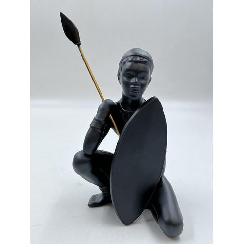 65A - A boxed Bossons African black painted pottery figurine of an African Man - measuring approx. 26cm hi... 