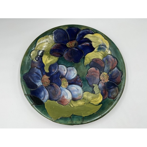 34 - A Moorcroft Pottery Clematis pattern plate - approx. 26cm diameter