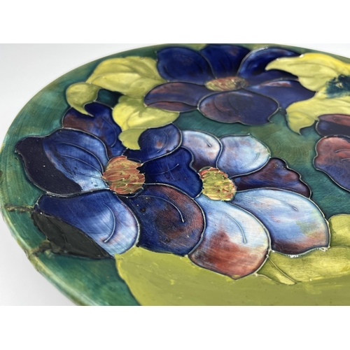 34 - A Moorcroft Pottery Clematis pattern plate - approx. 26cm diameter