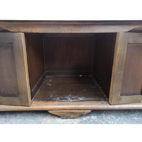 364 - An oak rectangular two tier coffee table with white painted top and two cupboard doors - approx. 42c... 