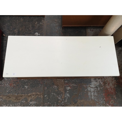 364 - An oak rectangular two tier coffee table with white painted top and two cupboard doors - approx. 42c... 