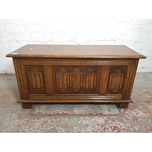 375 - An Old Charm oak linenfold blanket box - approx. 47cm high x 95cm wide x 39cm deep