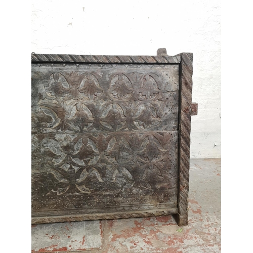 383 - An antique carved oak coffer - approx. 83cm high x 128cm wide x 40cm deep