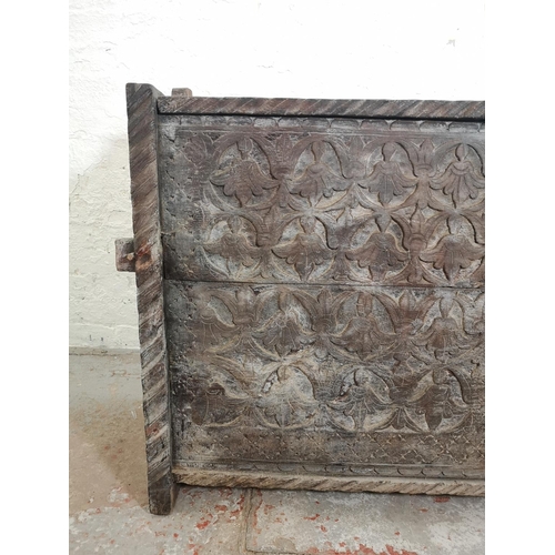 383 - An antique carved oak coffer - approx. 83cm high x 128cm wide x 40cm deep