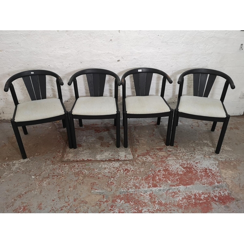 388 - A set of four mid 20th century black painted and striped upholstered dining chairs