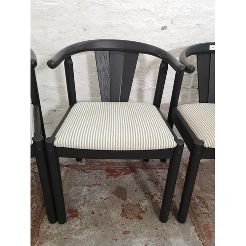 388 - A set of four mid 20th century black painted and striped upholstered dining chairs