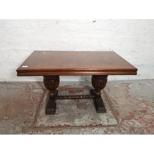 398 - An oak rectangular coffee table with carved baluster supports - approx. 49cm high x 55cm wide x 90cm... 