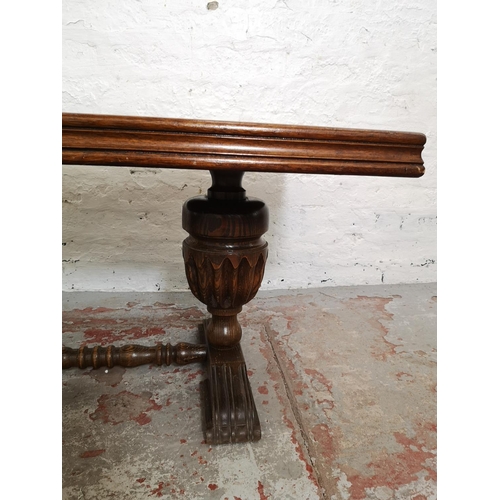 398 - An oak rectangular coffee table with carved baluster supports - approx. 49cm high x 55cm wide x 90cm... 