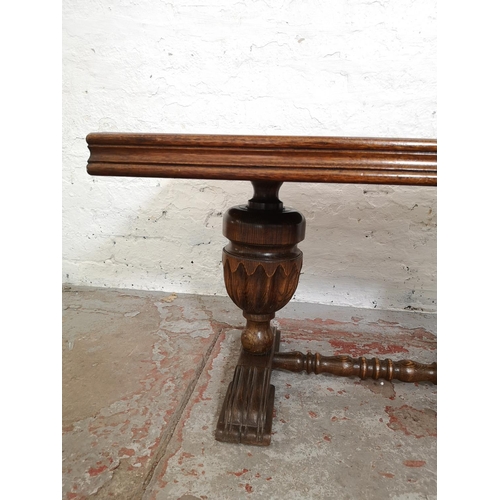 398 - An oak rectangular coffee table with carved baluster supports - approx. 49cm high x 55cm wide x 90cm... 