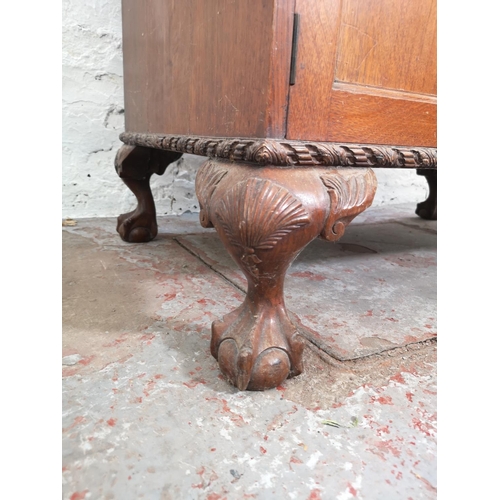 401 - An early/mid 20th century oak bureau with two drawers, two cupboard doors, fall front, ball and claw... 