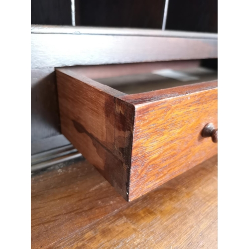 401 - An early/mid 20th century oak bureau with two drawers, two cupboard doors, fall front, ball and claw... 