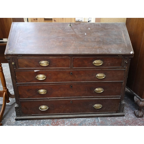 402 - A 19th century mahogany bureau with multiple secret drawers, two short drawers, three long drawers a... 