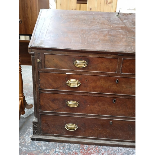 402 - A 19th century mahogany bureau with multiple secret drawers, two short drawers, three long drawers a... 