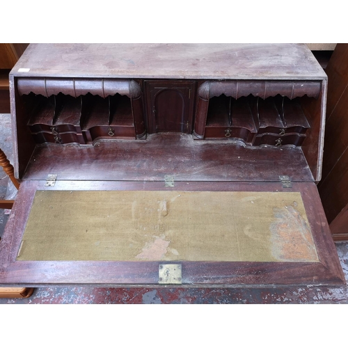 402 - A 19th century mahogany bureau with multiple secret drawers, two short drawers, three long drawers a... 