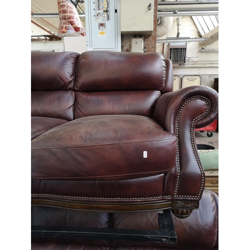 413 - A modern brown leatherette two piece lounge suite comprising three seater sofa and two seater sofa