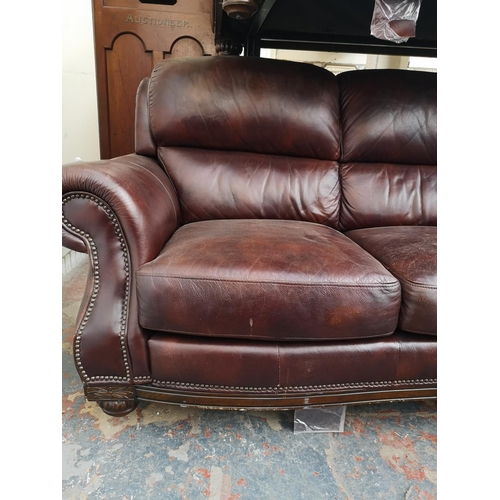 413 - A modern brown leatherette two piece lounge suite comprising three seater sofa and two seater sofa