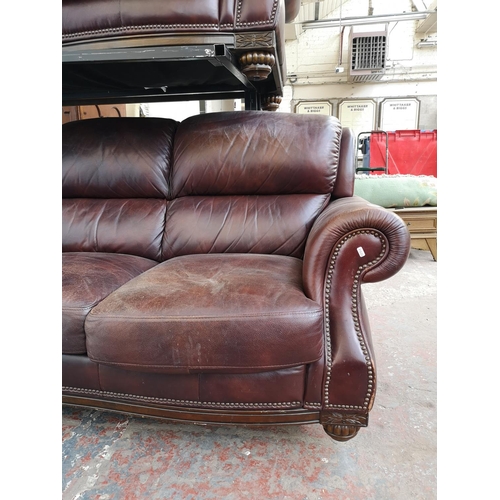 413 - A modern brown leatherette two piece lounge suite comprising three seater sofa and two seater sofa