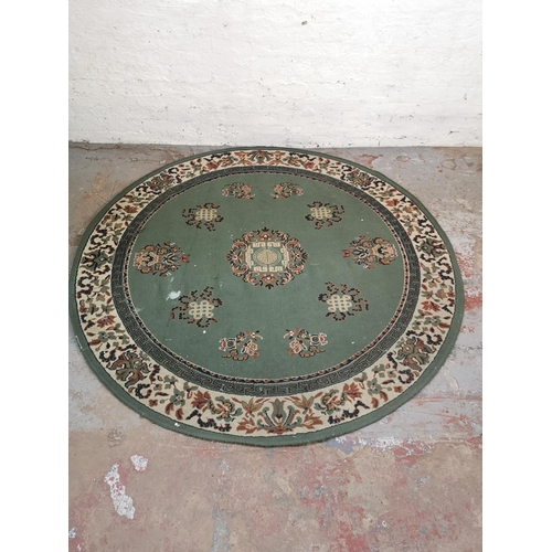 416 - A Chinese green floral patterned circular rug - approx. 200cm in diameter