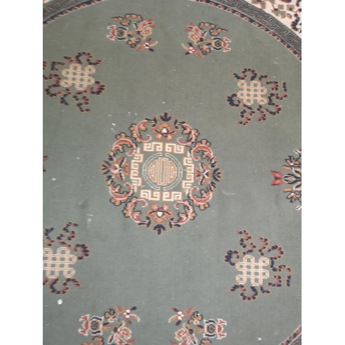 416 - A Chinese green floral patterned circular rug - approx. 200cm in diameter