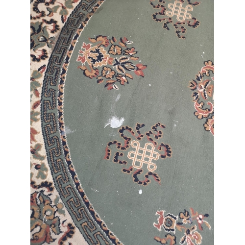 416 - A Chinese green floral patterned circular rug - approx. 200cm in diameter