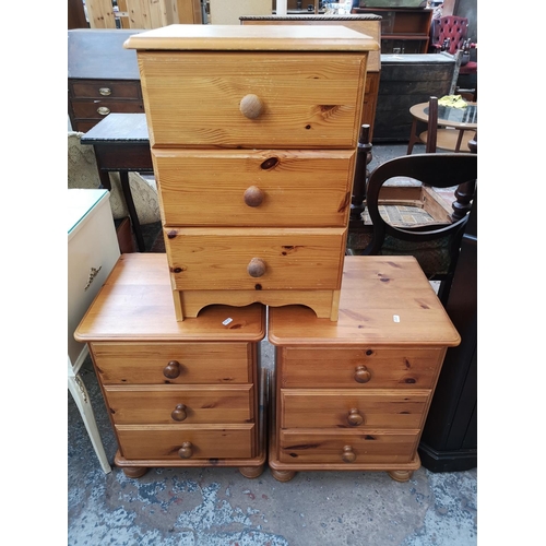 423 - Three modern pine bedside chests of three drawers